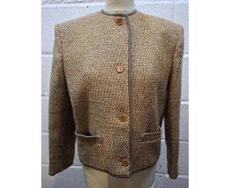 Gucci- A late 1970's G.Gucci Spa brown boucle box jacket having 4 front brown button fastening, padded shoulders, navy brande