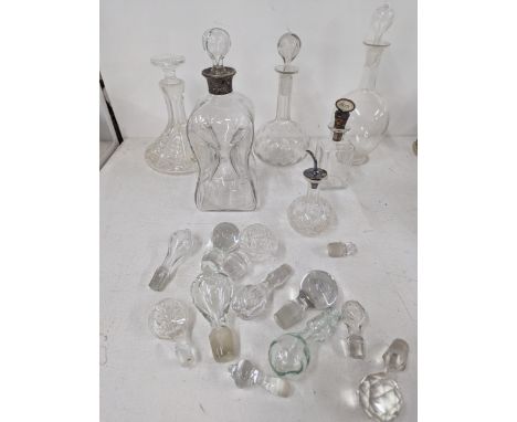 A selection of decanters to include an example with a silver collar, an Asprey bitters bottle and mixed stoppers A/FLocation: