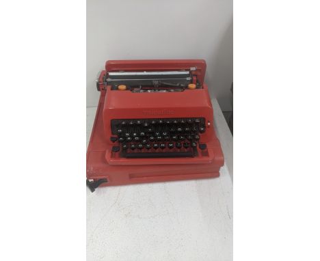 An Olivette Valentine typewriter in a red case, along with a collection of golf clubs in a Mizuno bagLocation: If there is no