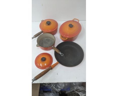 A collection of Le Creuset orange cookware to include a frying pan, a casserole dish, two saucepans and a lidLocation: If the