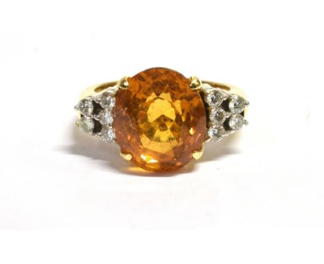 CITRINE &amp; DIAMOND DRESS RING Central oval mixed cut citrine estimated 4.8 carats, of very good quality, flanked by ten ro