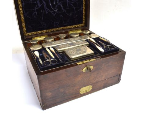 A VICTORIAN ROSEWOOD TRAVELLING TOILET BOX  with brass inlaid plaque to top and escutcheon, the lid opening to well fitted in