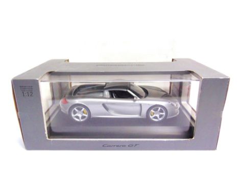 A DICKIE TOYS FOR PORSCHE 1/12 SCALE PORSCHE CARRERA GT  silver, mint and boxed.