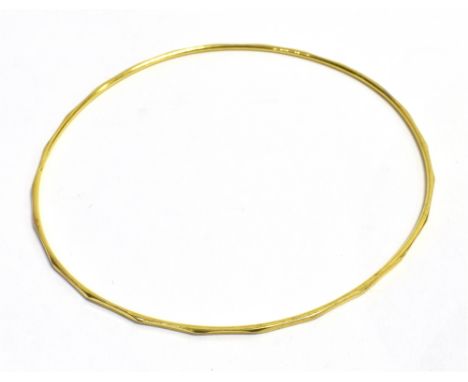 FINE GOLD FACETED BANGLE 7.0cm diameter, fine bangle with faceted decoration to outer edge.  Tests as 18ct.  Weight 2.3 grams