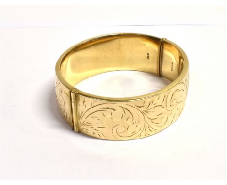 ROLLED GOLD ENGRAVED CUFF BANGLE 22.3mm wide with floral engraving to front and rear, hinge to side, with push button sliding