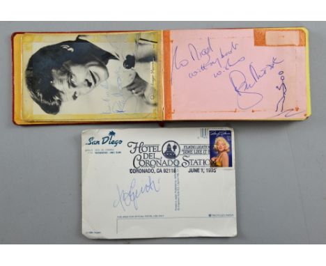 Autograph book with over 20 signatures including Roger Moore, Tony Curtis (signed postcard), Walker Brothers, Roy Orbison & o