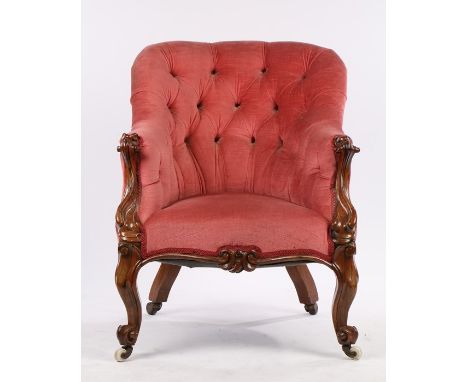 Victorian button back rosewood armchair, with an arched button back trailing to carved terminals and stuff over serpentine se