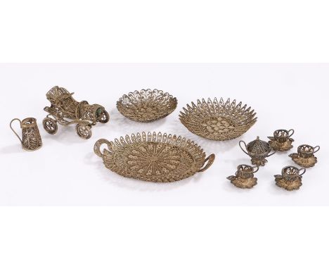 Silver filigree miniature tea service, consisting of oval twin handled tray, four teacups with attached saucers, jug, sugar b