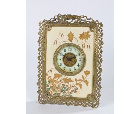 French 19th Century porcelain and brass easel clock, the porcelain front with gilt leaf decoration, the brass frame surmounte