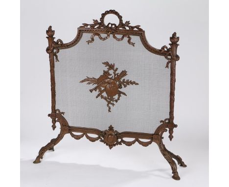 Copper firescreen, the central mesh with panel decorated with musical instruments and leaves, pierced tied ribbon and swag pe