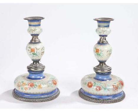 Pair of 19th Century silver and enamel candlesticks, with beaded sconces above foliate enamel and silver central columns and 