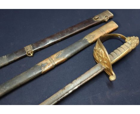 19th C Royal Navy Officers Dress Sword with 29 1/2inch pipe back blade with double pointed edge and engraved detail (pitted),