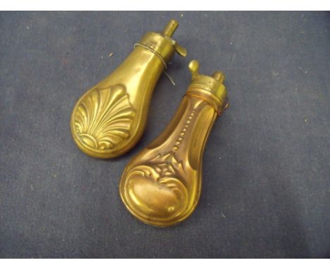 Small pistol powder flask with embossed shell design length 11cm (4 1/4 inch) and another similar (2) 