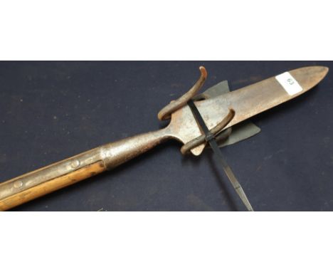 Late Victorian decorative broad bladed spear mounted on wooden ash shaft (overall length 182cm), with forge made wall hanging