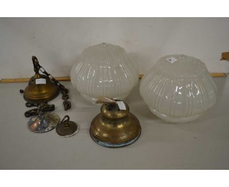 A pair of vintage light fittings with opaque glass shades