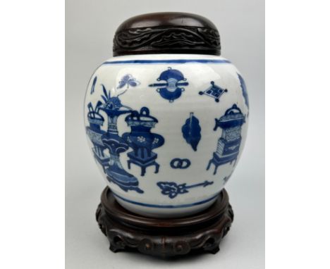 A CHINESE PORCELAIN KANGXI JAR AND COVER, Qing dynasty, Kangxi reign (1662-1772) blue and white with one side depicting vases