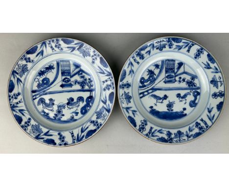 A PAIR OF CHINESE KANGXI PERIOD (1662-1722) 'CHICKEN DISHES', Blue and white painted with scenes of chickens.22cm D each 