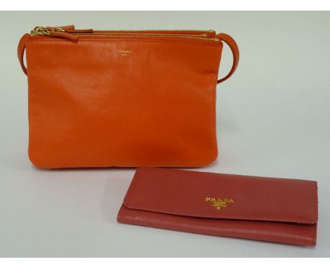 A Celine 'Trio' coral leather handbag,with three zip sectioned interiors, with carrying strap, anda Prada pink saffiano leath