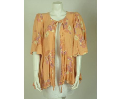 An original Biba 1960s peach-coloured flared top,with floral pattern, large flared sleeves, tie to neck and flared hem,a Biba