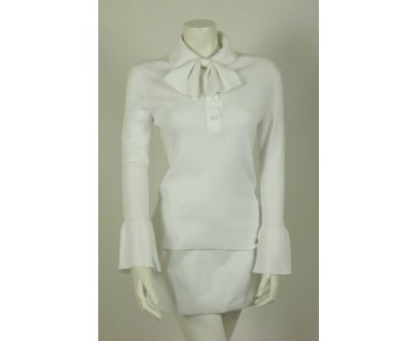 A Chanel white cotton knitted top,with pussy bow to neck, three small buttons to hemline and flared sleeves, anda Chanel blac