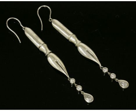 A pair of sterling silver diamond set drop earrings in the form of fountain pen nibs,with two brilliant cut and one pear cut 