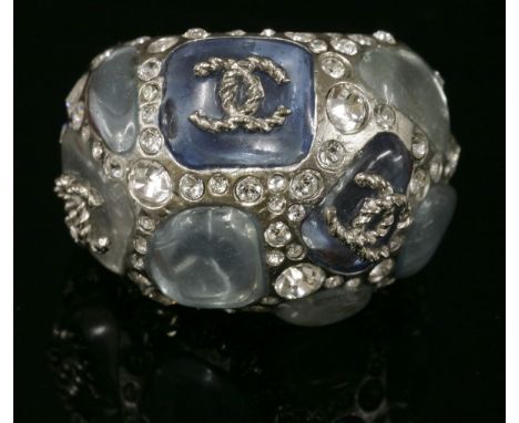 A Chanel bombé ring,No. B12C, with freeform varicoloured blue cabochons, between lines of graduated paste stones, applied ent