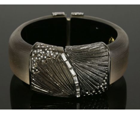 An hinged Lucite and paste set bangle,by Alexis Bittar, 39mm wide, a smoke-grey Lucite cuff with black rhodium-plated reeded 