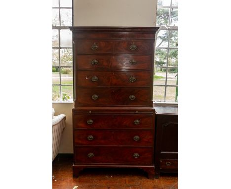 A George III flame mahogany chest on chest, circa 1770, dentil cornice, two short over three long drawers flanked by chamfere