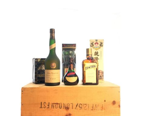 Seven bottles of mixed liqueurs and brandies, in a woven hamper. ( 7)