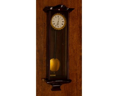 A small late 19th Century single weight Vienna wall clock, serpentine shaped cornice above glazed door, white enamel face wit