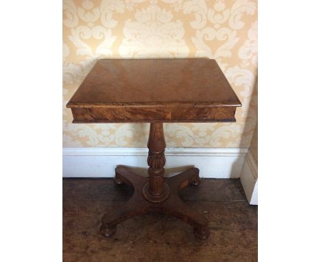 A Late Regency rectangular burr walnut wine table, circa 1815, on a carved turned collumn to a platform base on bun feet and 