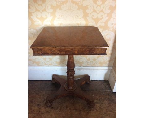 A Late Regency rectangular burr walnut wine table, circa 1815, on a carved turned collumn to a platform base on bun feet and 