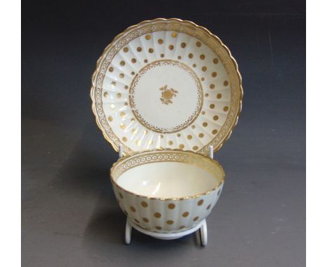 A Caughley  gilt and white tea bowl and saucer, Polka Dot pattern, circa  1780, tea bowl 8.8cm diameter,  6cm high, saucer 14