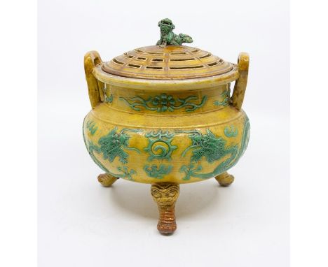 A Chinese porcelain tripod censer and cover, Qing dynasty, 18th/19th Century, with overall yellow glaze, with a pair of drago