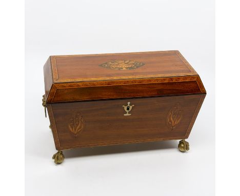 A Regency mahogany tea caddy. circa 1820, of sarcophagus form, the cover with central marquetry inlay of a vase of flowers, c