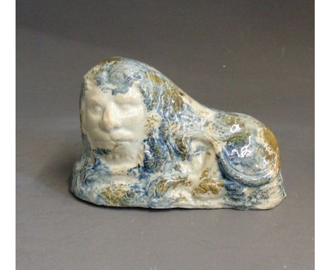 A Staffordshire pottery model of a lion decorated  with coloured glazes, circa 1790-1800, 10cm wide,  6.5cm highCondition: fe