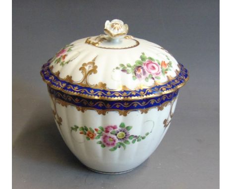 A Worcester sucrier and cover of fluted form painted with flowers under a blue and gilt border, circa 1772-75, 13cm high, 11c