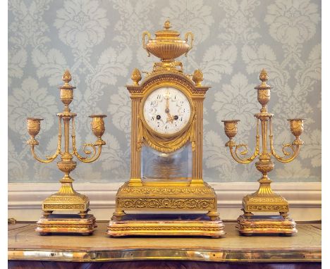 A 19th Century French gilt ormolu clock garniture, of Baroque design, urn and pineapple finials, 10cm enamel dial with Arabic