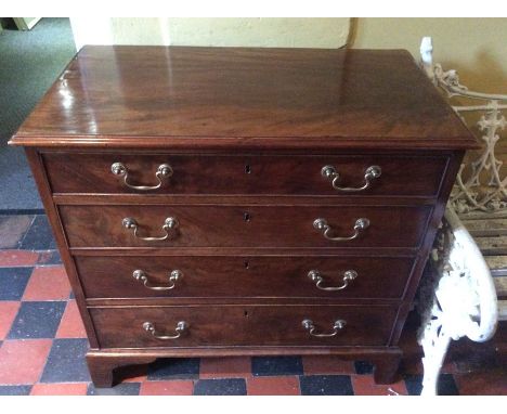A George III mahogany chest of drawers, moulded cornice above four long graduated drawers with swan neck brass handles on car