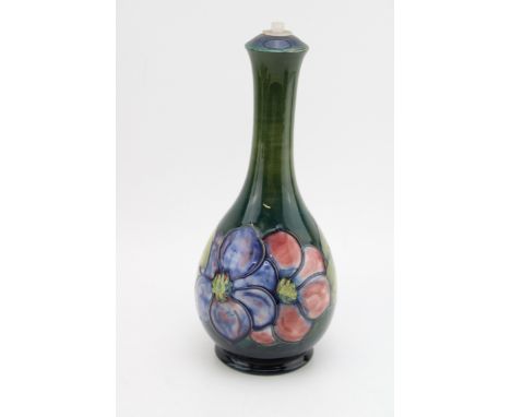 Moorcroft lampbase on green background, 28cm tall.  In good condition with no obvious damage or restoration.