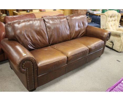 A BROWN LEATHER MODERN THREE SEATER SOFA