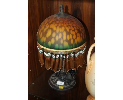 A RETRO CAST LAMP WITH COLOURED GLASS SHADE 