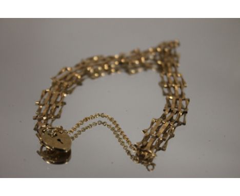 A SMALL YELLOW METAL GATE BRACELET