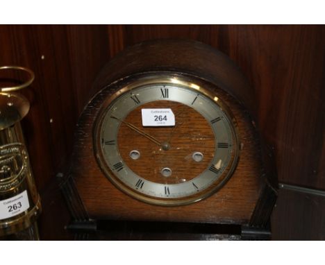 AN ART DECO STYLE OAK MANTLE CLOCK WITH KEY