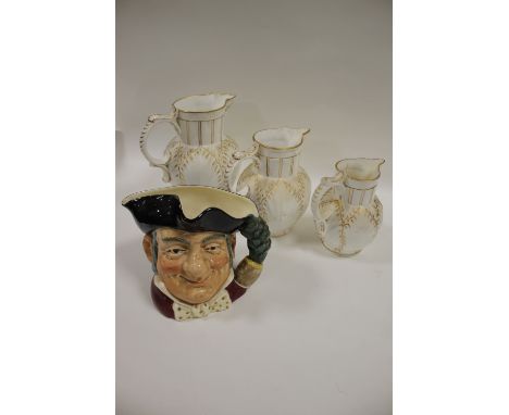 A GRADUATED SET OF THREE ROYAL WORCESTER STYLE JUGS WITH BACCHANALIAN MASK DETAIL TOGETHER WITH A ROYAL DOULTON MINE HOST LAR