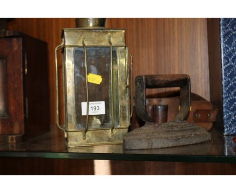 A BRASS LANTERN TOGETHER WITH A FLAT IRON & AMMUNITION BELT 