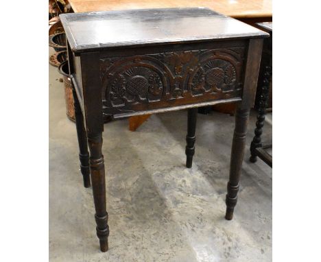 A 17th century and later oak bible box with hinged top and thistle carved front panel on turned supports, 56 cm w x 42 cm d x