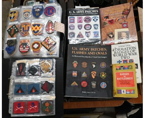 A large collection of US Army patches and badges, to/w various related books