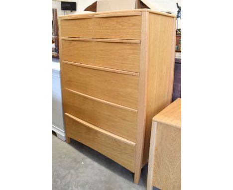 A modern light oak tallboy chest of four short over three long drawers with moulded handles, 88 cm w x 45 cm d x 124 cm h