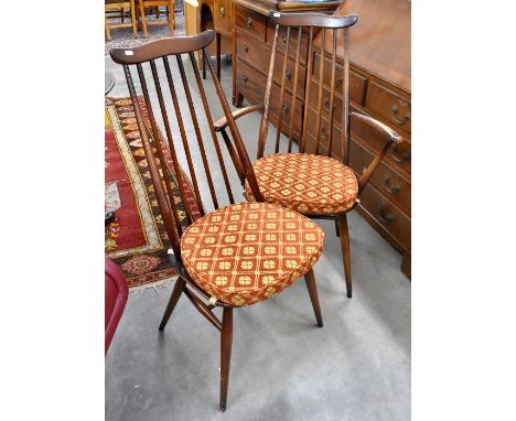 A set of six Ercol dark elm dining chairs, tall spindle backs with shaped top-rails, four standard and two carvers (6)